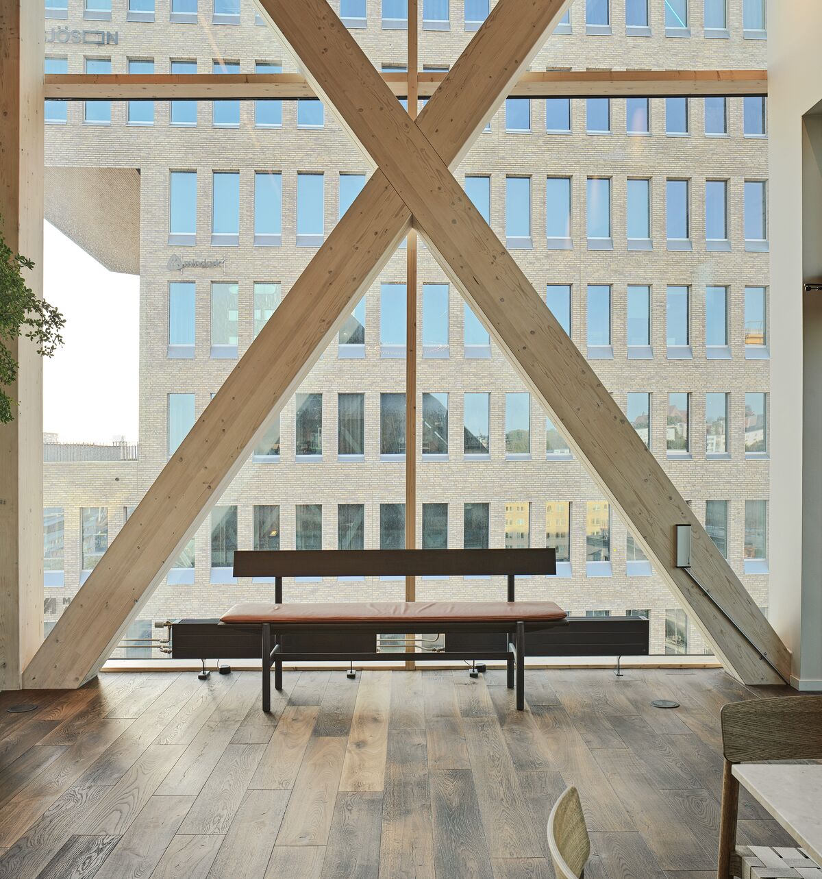 Interior view of wooden beams, launch chair and glass windows