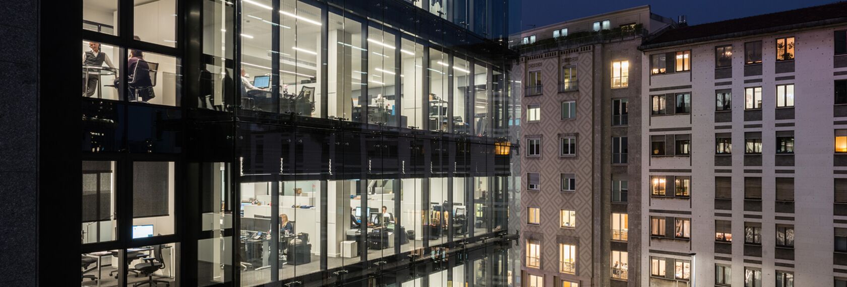 Night view of Largo Augusto office building in Milan, Italy.