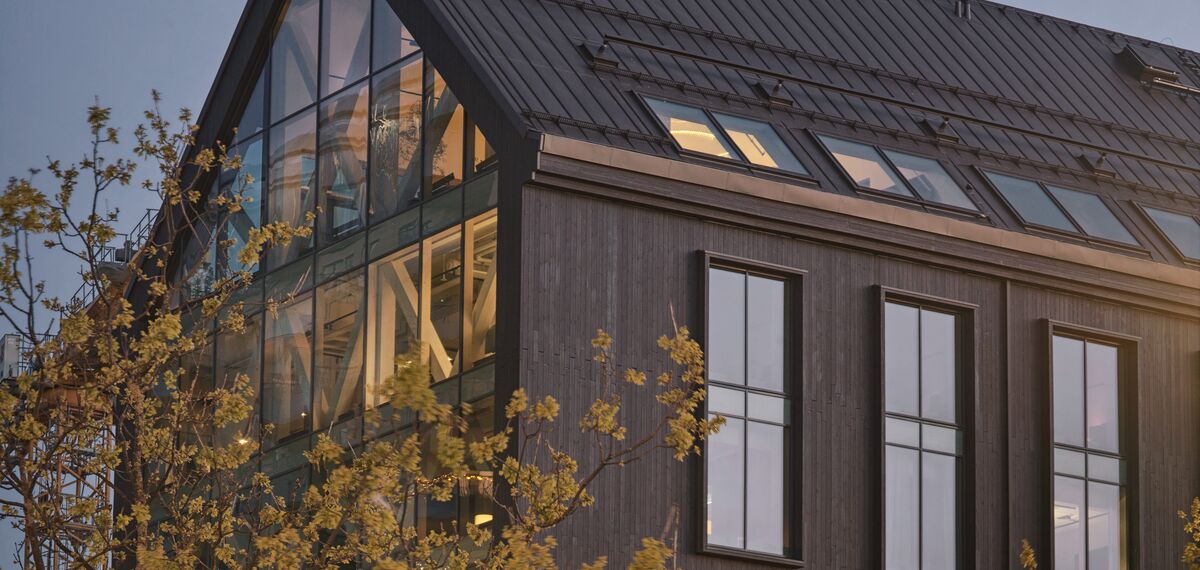 Habitat 7 Building in Sweden, with tree and wood façade.