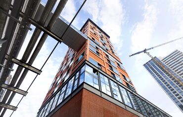 Angled view of orange high-rise building.